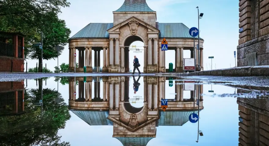 Odbicie zabytkowej budowli w kałuży po deszczu. Warto zobaczyć to miejsce w Szczecinie, szczególnie po opadach.
