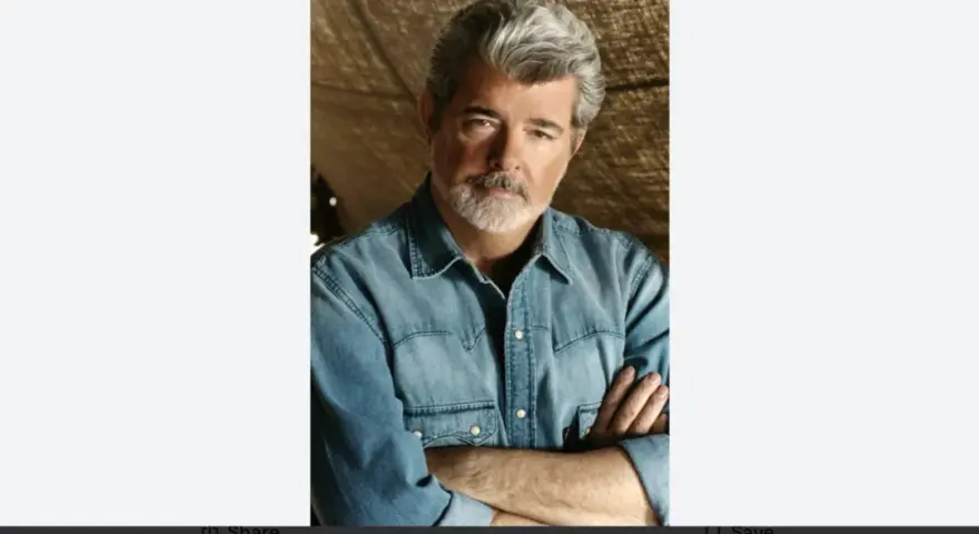 George Lucas, uno dei registi importanti, con barba grigia e camicia di jeans, braccia conserte.