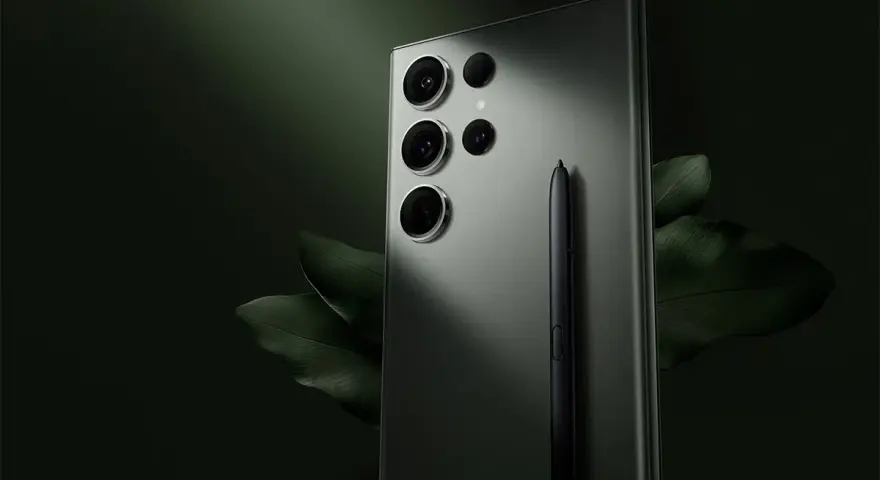 Elegancki samsung s23 aparat z piórkiem S Pen, otoczony ciemnozielonymi liśćmi.