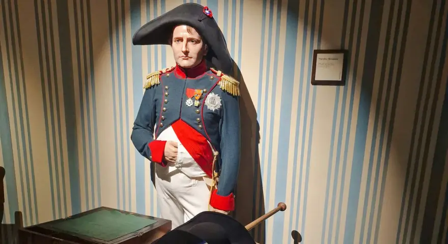 Napoleon Bonaparte w muzeum figur woskowych w Paryżu. Jego postać w historycznym mundurze przyciąga wzrok.