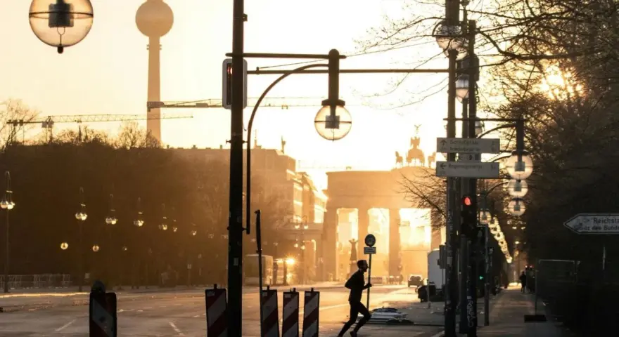 A lone runner passes the Brandenburg Gate at sunrise. This iconic Berlin landmark is a must-see, no matter how many days in Berlin you have.