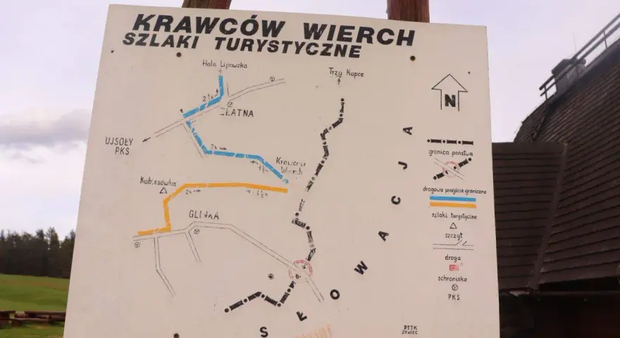Mapa szlaków turystycznych na Krawców Wierch. Widać szlaki niebieskie, żółte i czarne, punkty PKS, schroniska i przejścia graniczne.