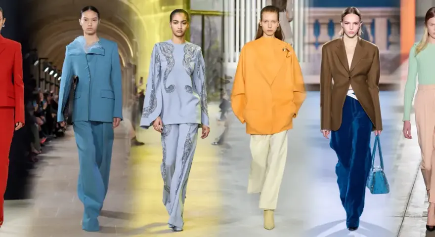 Modelli sfilano con eleganti completi pantalone, un'idea chic per come vestirsi ad un matrimonio con pantaloni.