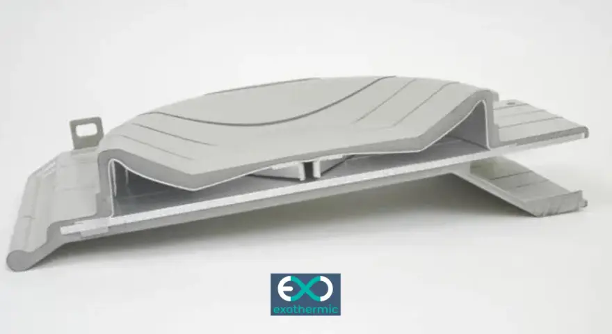 A complex, layered component showcasing advanced forming plastics, with a subtle wave pattern on the top surface.