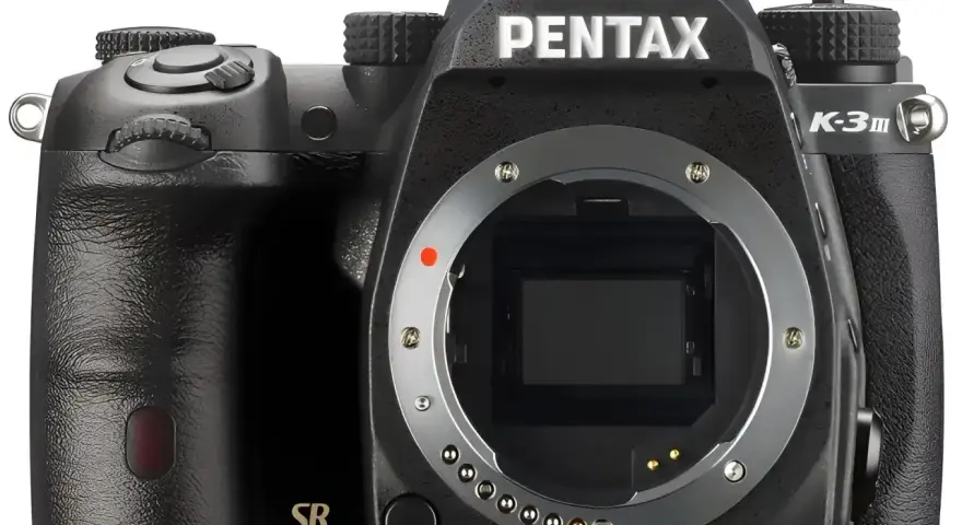 Czarny aparat Pentax K-30 z widocznym bagnetem obiektywu i oznaczeniem "SR". Gotowy do uchwycenia wyjątkowych chwil.