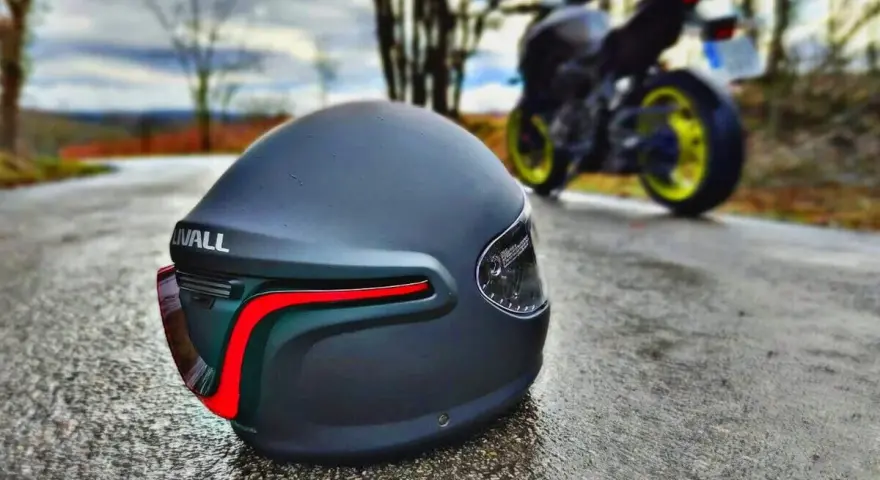 Casco negro mate con luces traseras rojas, listo para la aventura. Los mejores cascos de seguridad para tu moto.