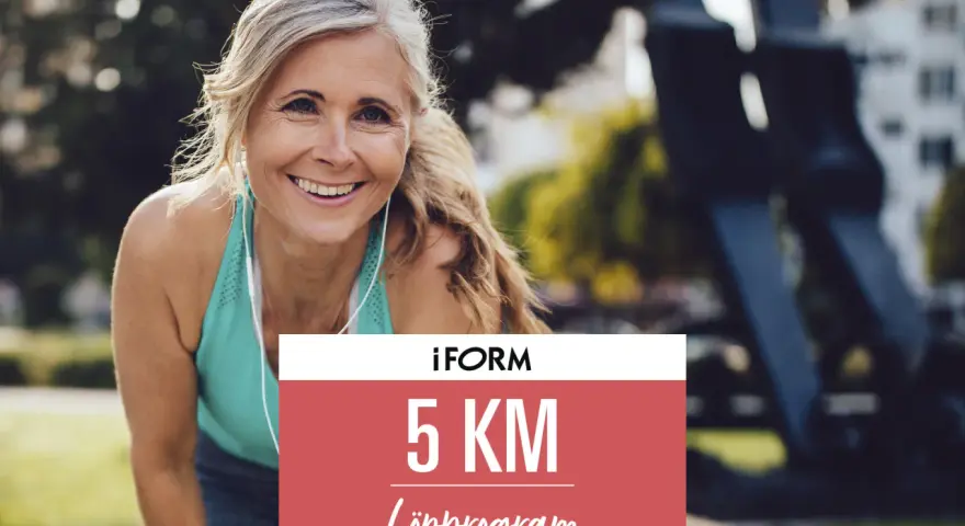 Glad kvinna redo att springa 5 km. Hennes löpprogram från iForm väntar.