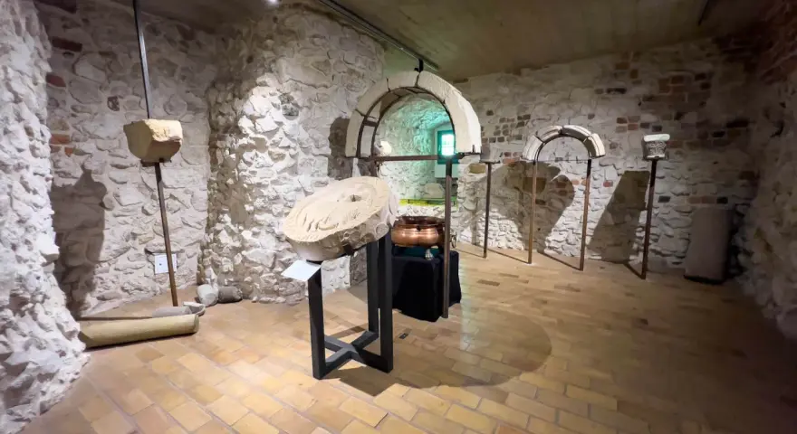 Wnętrze klasztoru w Tyńcu. Kamienne ściany, łuki i artefakty tworzą atmosferę historii.