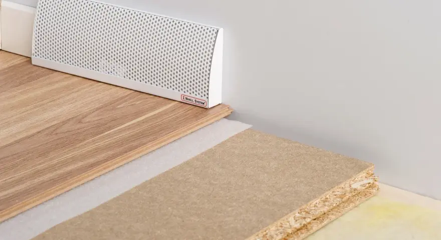 En vit ventilationslist för ett passivt ventilerat golv, med trägolv och byggmaterial.