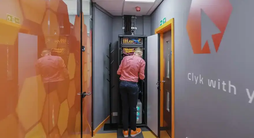 Technician working on network infrastructure services in a server room.