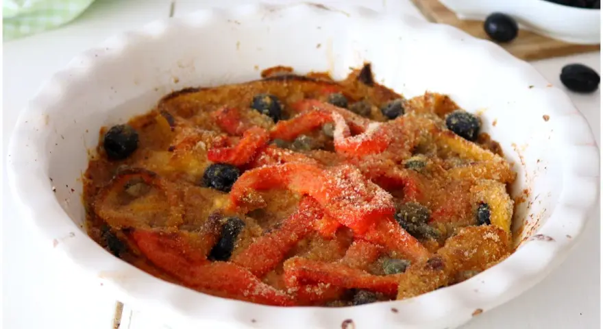 Peperoni gratinati al forno, un piatto saporito con olive nere e capperi, pronto per essere gustato.