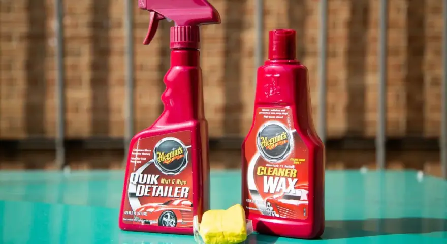 Car detailing supplies: Meguiar's Quik Detailer, Cleaner Wax, and a clay bar for a smooth finish.