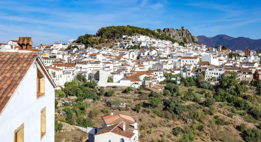 A picturesque white village cascades down a hillside, perfect for a southern Spain itinerary.