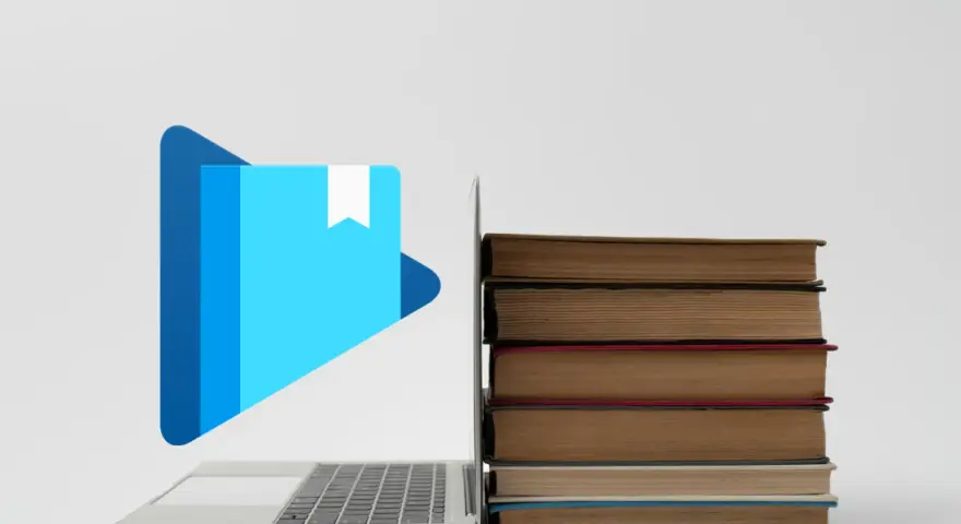 Laptop z ikoną książki i stosem książek. Jak otworzyć plik epub?