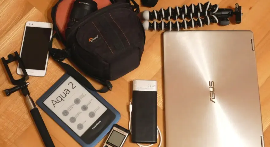 Elektronika i akcesoria podróżne: smartfon, czytnik e-booków, aparat, powerbank, laptop, selfie stick i statyw.