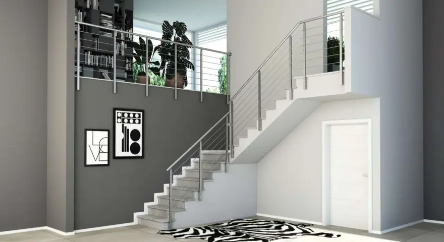 Moderne idee ringhiere scale interne in acciaio inox, con libreria a muro e quadri astratti.