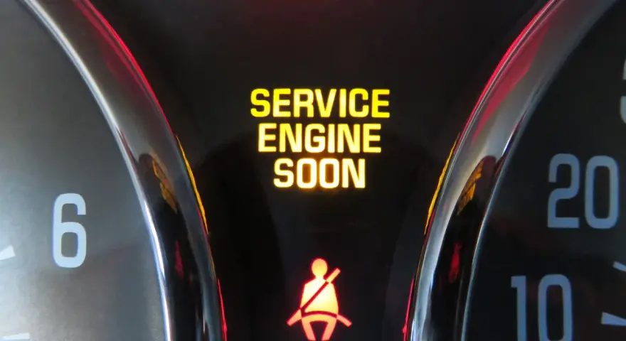 Dashboard lights show "SERVICE ENGINE SOON" and a seatbelt warning. This is a common indicator that it's time to figure out how to reset check engine light.