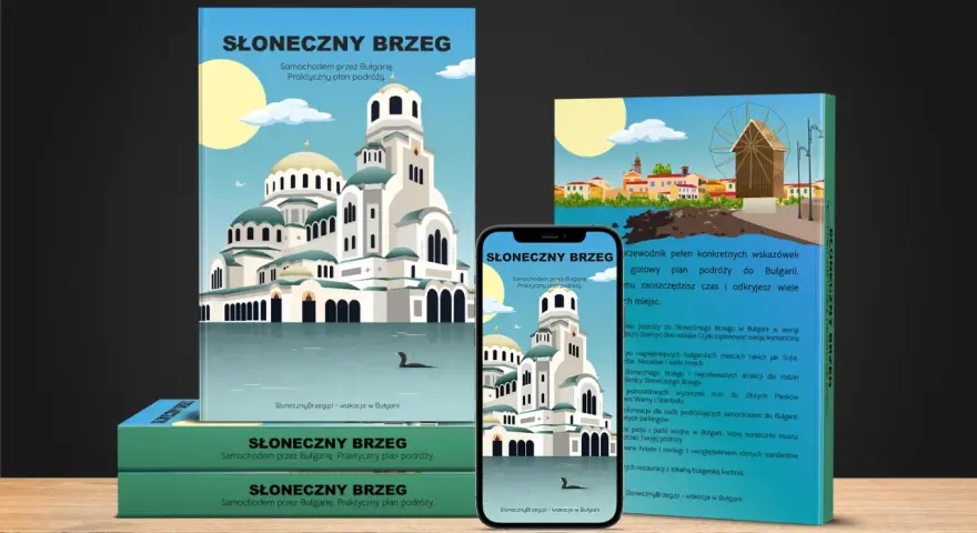 Okładki przewodników i smartfon z widokiem na cerkiew i plażę.