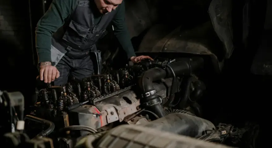 Mechanik bada silnik, szukając oznak nieszczelnej odmy.