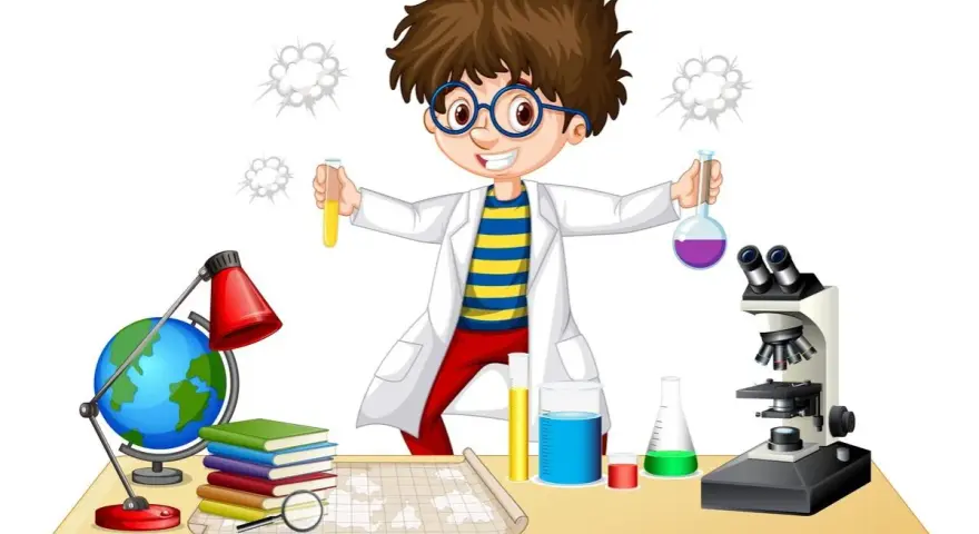 Chłopiec w fartuchu laboratoryjnym z dumą prezentuje swoje **eksperymenty chemiczne dla dzieci**. Na stole stoją probówki, mikroskop i globus.