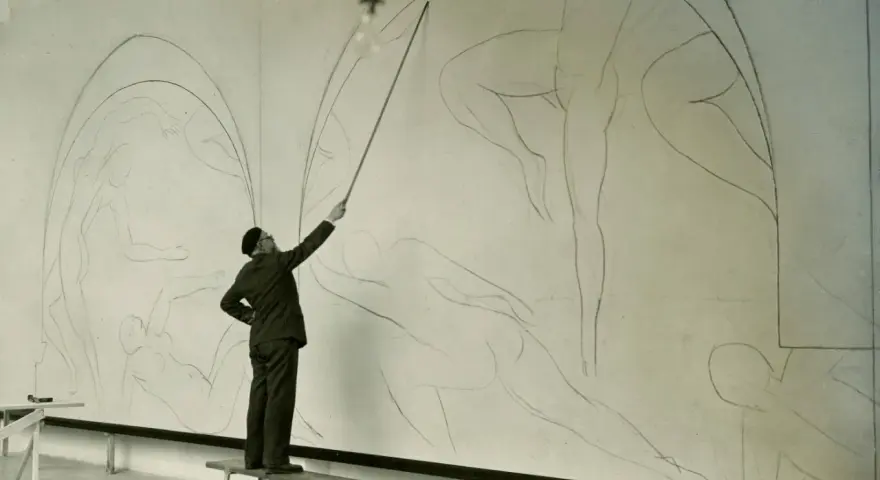 Henri Matisse, z laską w dłoni, kieruje pracami nad szkicem swojego słynnego "Tańca".