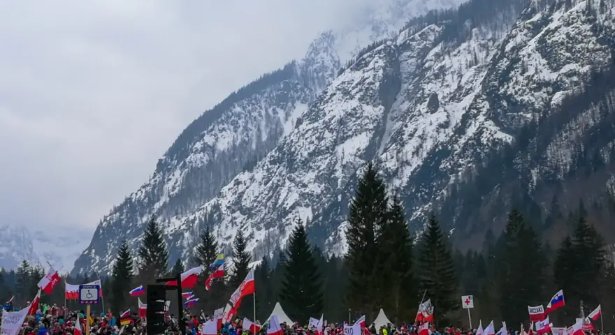 Tłum kibiców z flagami w słoweńskiej Planicy, gdzie znajduje się słynna skocznia narciarska.