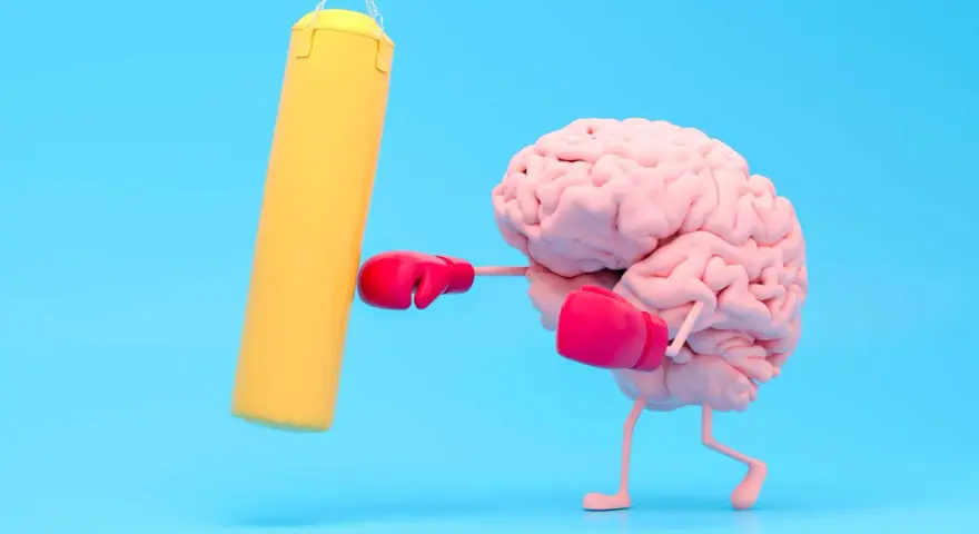 Cervello con guantoni da boxe rosa colpisce un sacco giallo, un modo per risollevare l'umore.