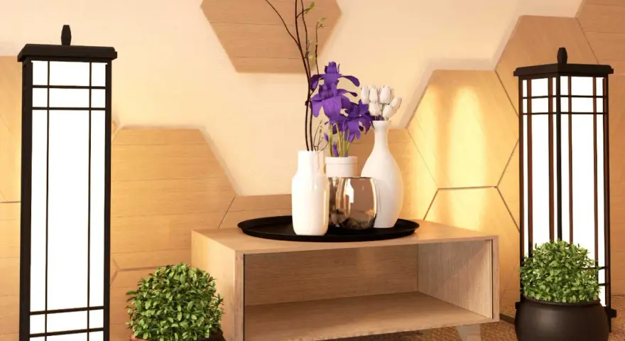 Ideas para como adornar una mesa de salon: dos lámparas, plantas, jarrones con flores y un detalle metálico sobre un mueble de madera.