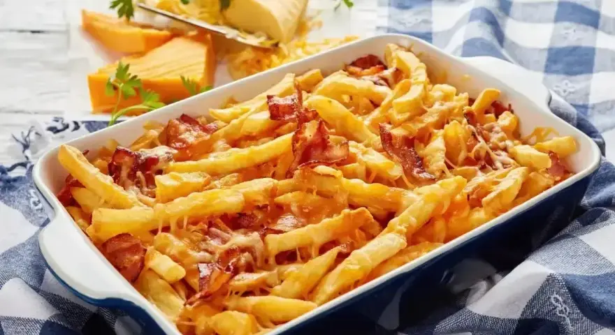 Zapiekane frytki z serem i chrupiącym boczkiem wprost rozpływają się w ustach. Idealna przekąska dla każdego!