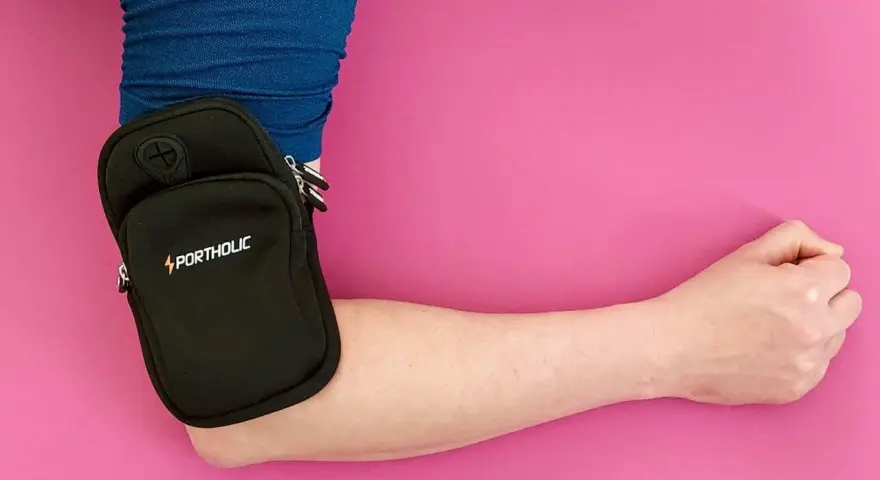 Kleiner schwarzer Portholic-Beutel am Arm, praktisch für Sport oder unterwegs.