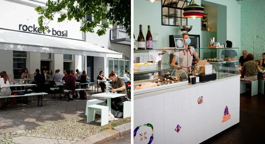 Außenbereich eines Restaurants in Berlin mit Gästen, innen ein Tresen mit einer Mitarbeiterin. Ein gemütliches persisches Restaurant Berlin.