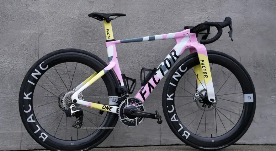 A stylish pink, yellow, and grey Factor road bike, perfect for women beginners looking for a fun and fast ride.