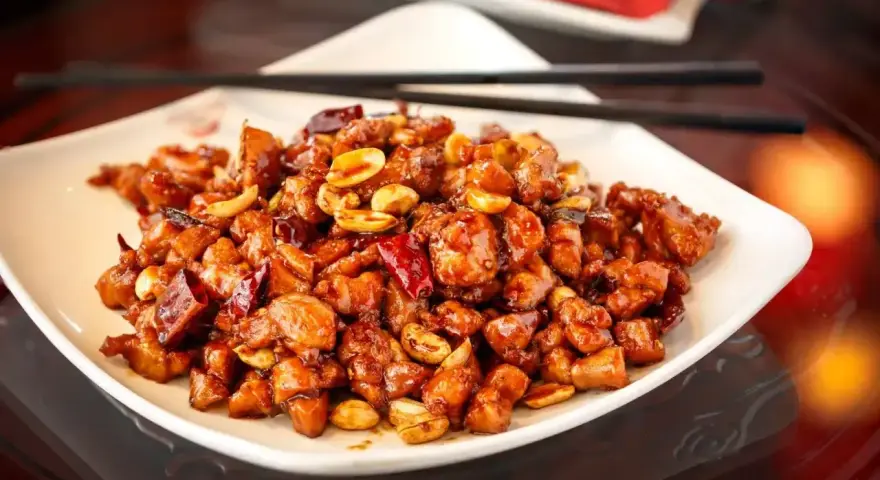 Kurczak Kung Pao, jak Król Małp, w sosie z orzeszkami ziemnymi i papryczkami chili.