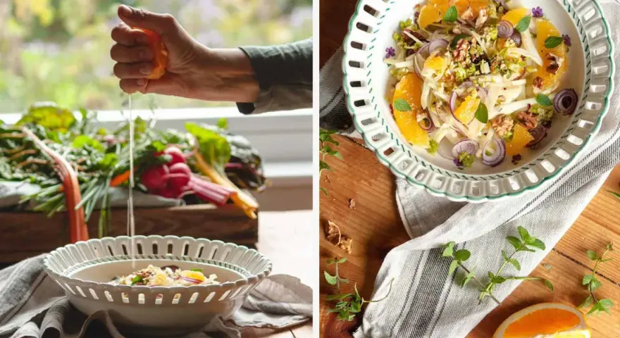 Frische Zutaten für eine insalata siciliana: Fenchel, Orange, rote Zwiebeln und Walnüsse werden in einer Schüssel angerichtet.