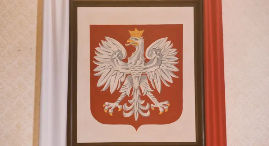 Obraz przedstawia godło Polski – białego orła w koronie na czerwonej tarczy.