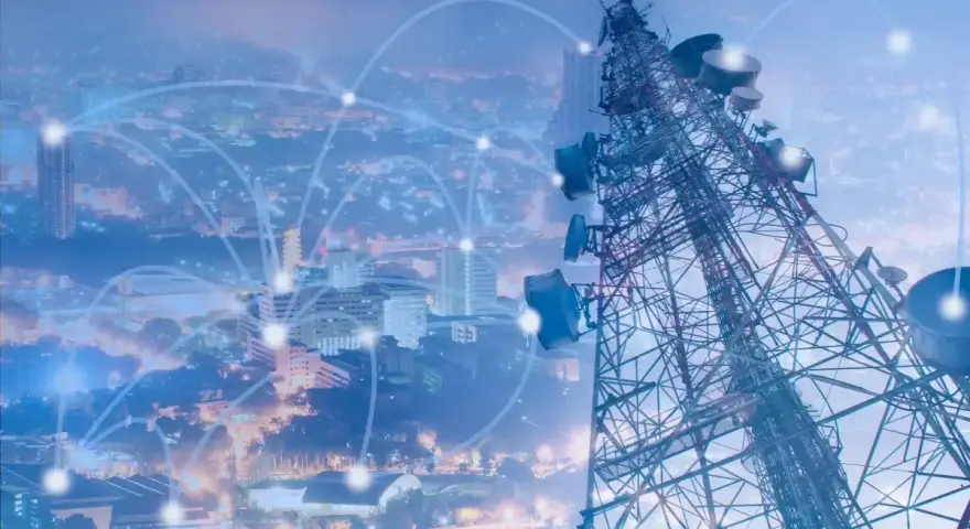A telecommunications tower overlooks a city, with glowing lines connecting points, symbolizing network planning and optimization.
