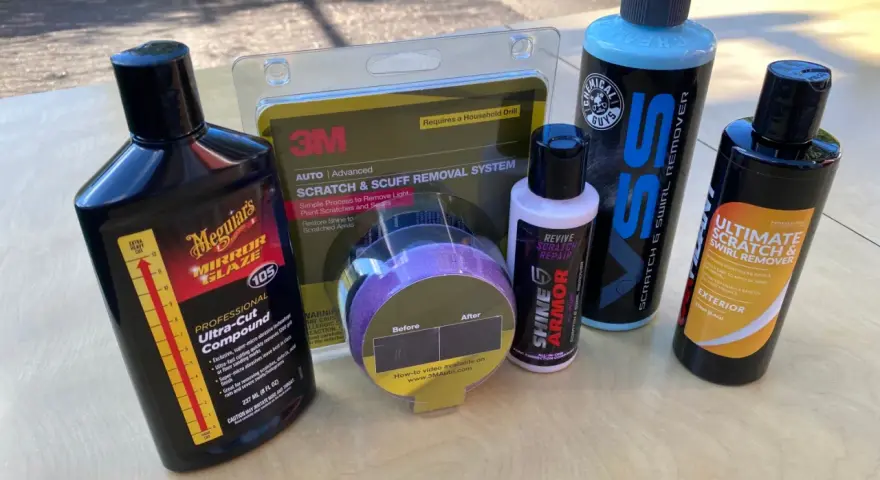 Car scratch removal products, including rubbing compound, are laid out, ready to tackle paint scratches and swirls.