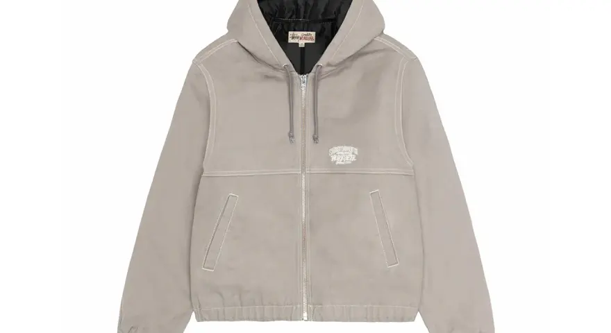 Giacca Stussy work jacket grigia con cappuccio, zip frontale e logo ricamato sul petto. Perfetta per un look casual e resistente.