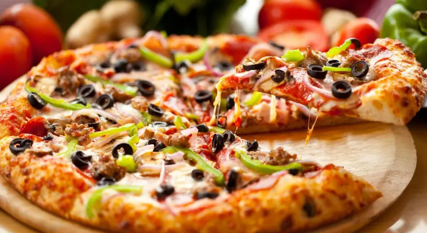 Gotowe ciasto na pizzę z mnóstwem dodatków: pepperoni, oliwki, papryka, cebula i ser. Idealne na wieczór filmowy!