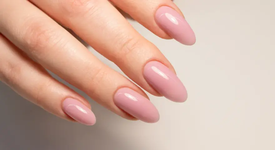 Mano con unghie naturali rosa pallido, forma a mandorla.