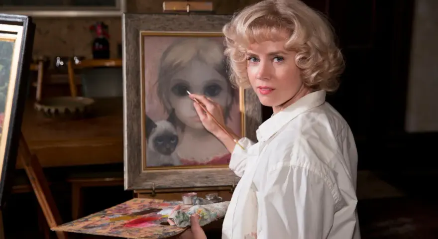 Margaret Keane målar en flicka med stora ögon och en siamesk katt.