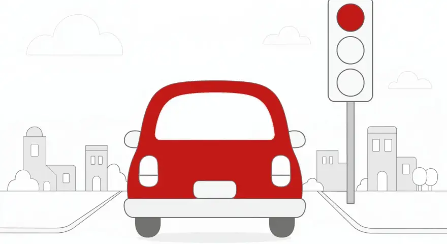 Czerwony samochód ignoruje czerwone światło na sygnalizacji świetlnej, jadąc przez miasto.