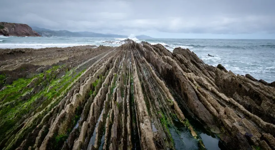 Dramatic rock formations on a rugged coastline, a perfect spot for day trips from Bilbao.