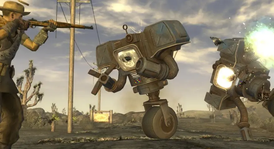 Un personaje con rifle dispara a robots en el desierto. ¡Descubre trucos de Fallout: New Vegas para sobrevivir!