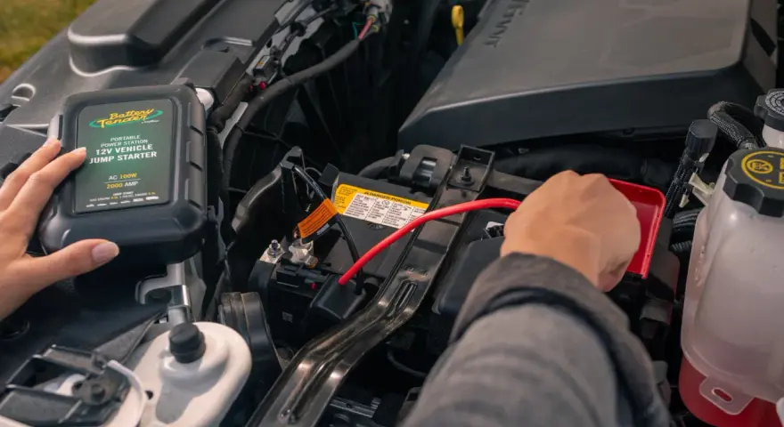 A person connects a Battery Tender jump starter to a car battery. This answers the question: do jump starters come charged?