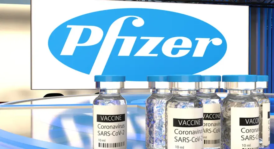 Szczepionki Pfizer na COVID-19 w ampułkach, z logo firmy w tle.