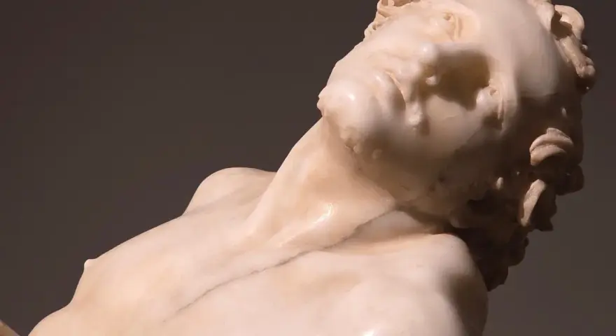 Rzeźba z marmuru przedstawiająca męskie ciało w dramatycznej pozie, dzieło Gian Lorenzo Bernini.