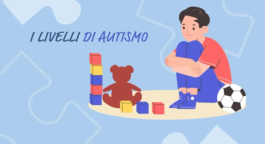 Un bambino con autismo livello 2 gioca con blocchi e un orsacchiotto, mentre un pallone da calcio è vicino.