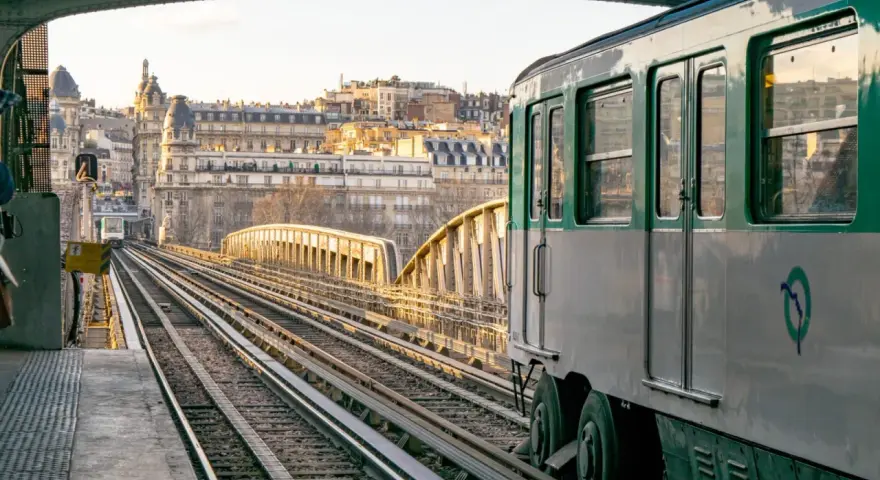 Un tren del metro de París, Francia, avanza por las vías al atardecer.