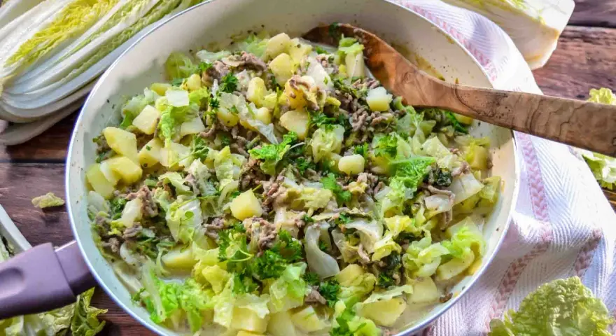 Herzhaftes Chinakohl Rezept mit Hackfleisch und Kartoffeln in einer Pfanne, garniert mit Petersilie.